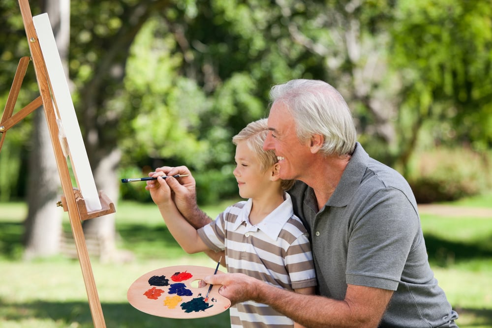 Grandfather painting with his grandson